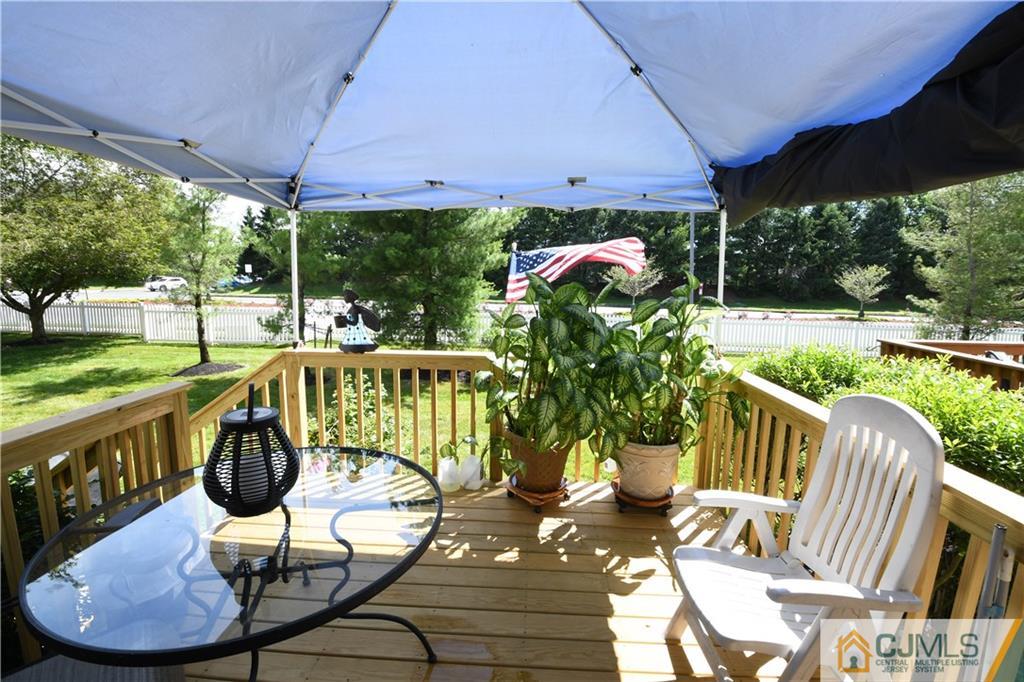 171 Salem Road North Brunswick, NJ 08902 - Photo 12 of 44 a view of a patio with a table chairs and a swimming pool