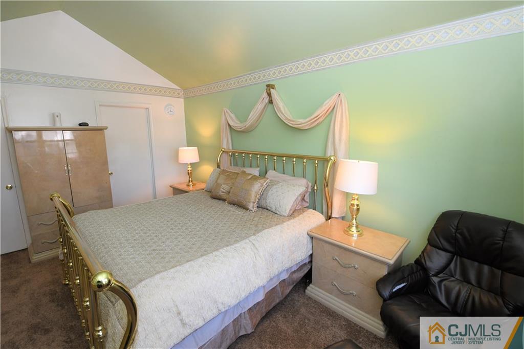 171 Salem Road North Brunswick, NJ 08902 - Photo 17 of 44 a bed room with a bed and a lamp