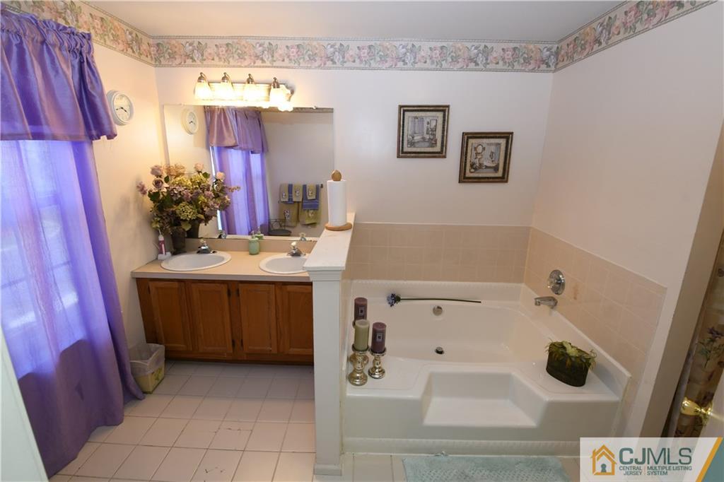 171 Salem Road North Brunswick, NJ 08902 - Photo 23 of 44 a bathroom with a sink a vanity and mirror