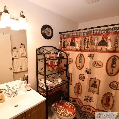 171 Salem Road North Brunswick, NJ 08902 - Photo 32 of 44 a bathroom with a sink and a mirror