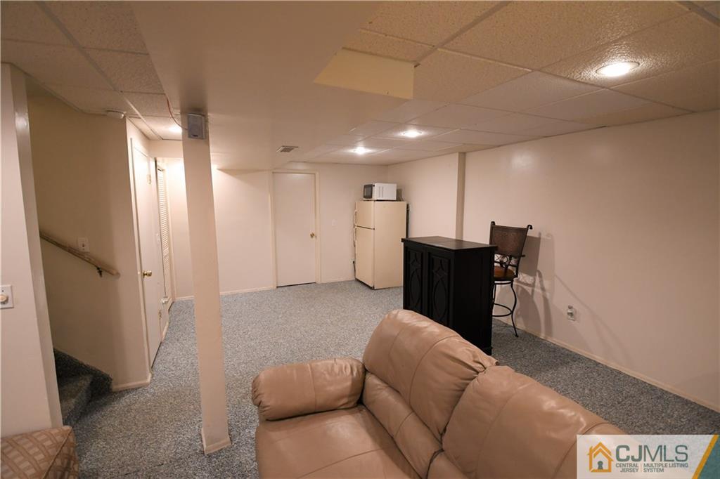 171 Salem Road North Brunswick, NJ 08902 - Photo 9 of 44 a living room with furniture and a refrigerator