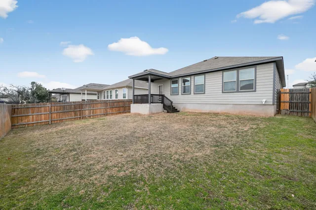 a view of a house with a backyard and a garden