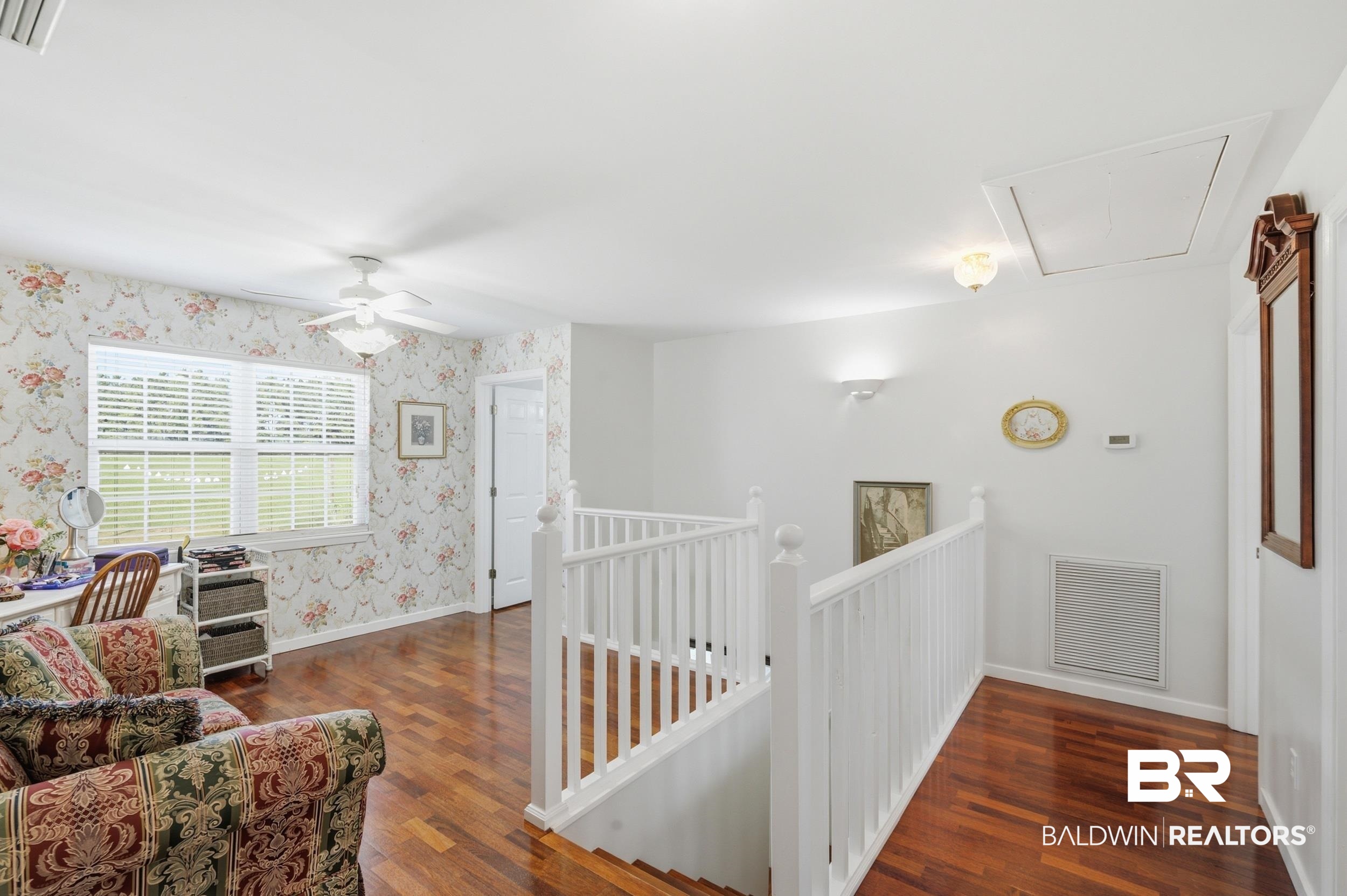 15855 Calvin Richerson Road Bay Minette, AL 36507 - Photo 45 of 83 Spacious loft area featuring wood-finish flooring, white baluster railings, and a ceiling fan with integrated lighting