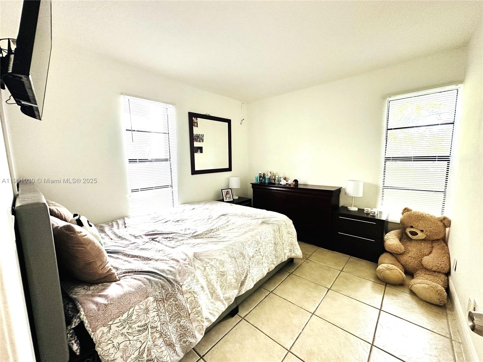 3037 Northwest 118th Drive, Unit 122D Coral Springs, FL 33065 - Photo 17 of 25 a bedroom with a bed and a window