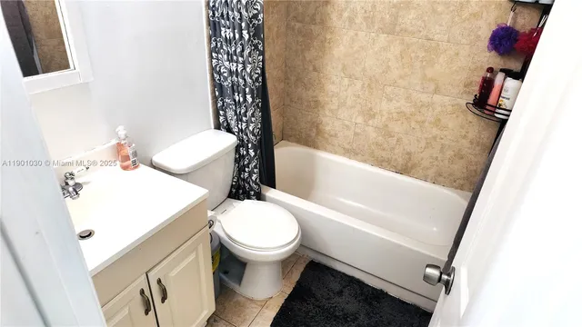 a white toilet sitting next to a bath tub