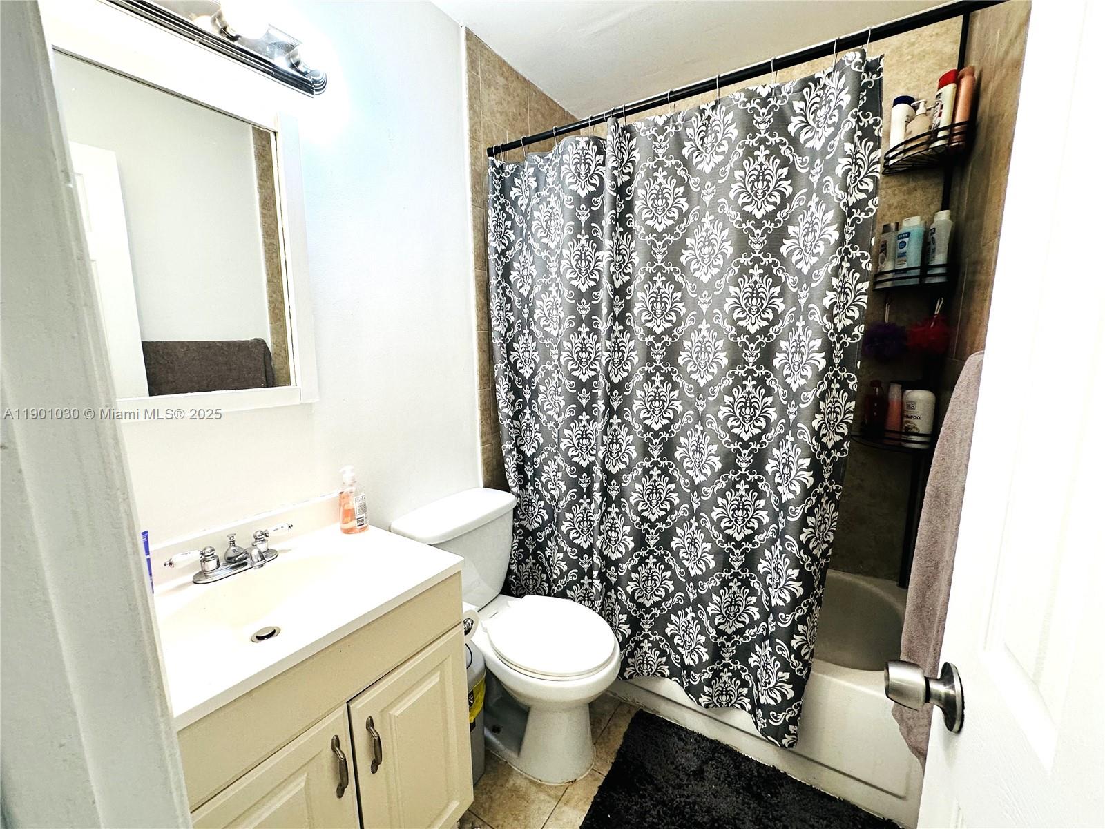 3037 Northwest 118th Drive, Unit 122D Coral Springs, FL 33065 - Photo 19 of 25 a bathroom with a sink toilet and shower