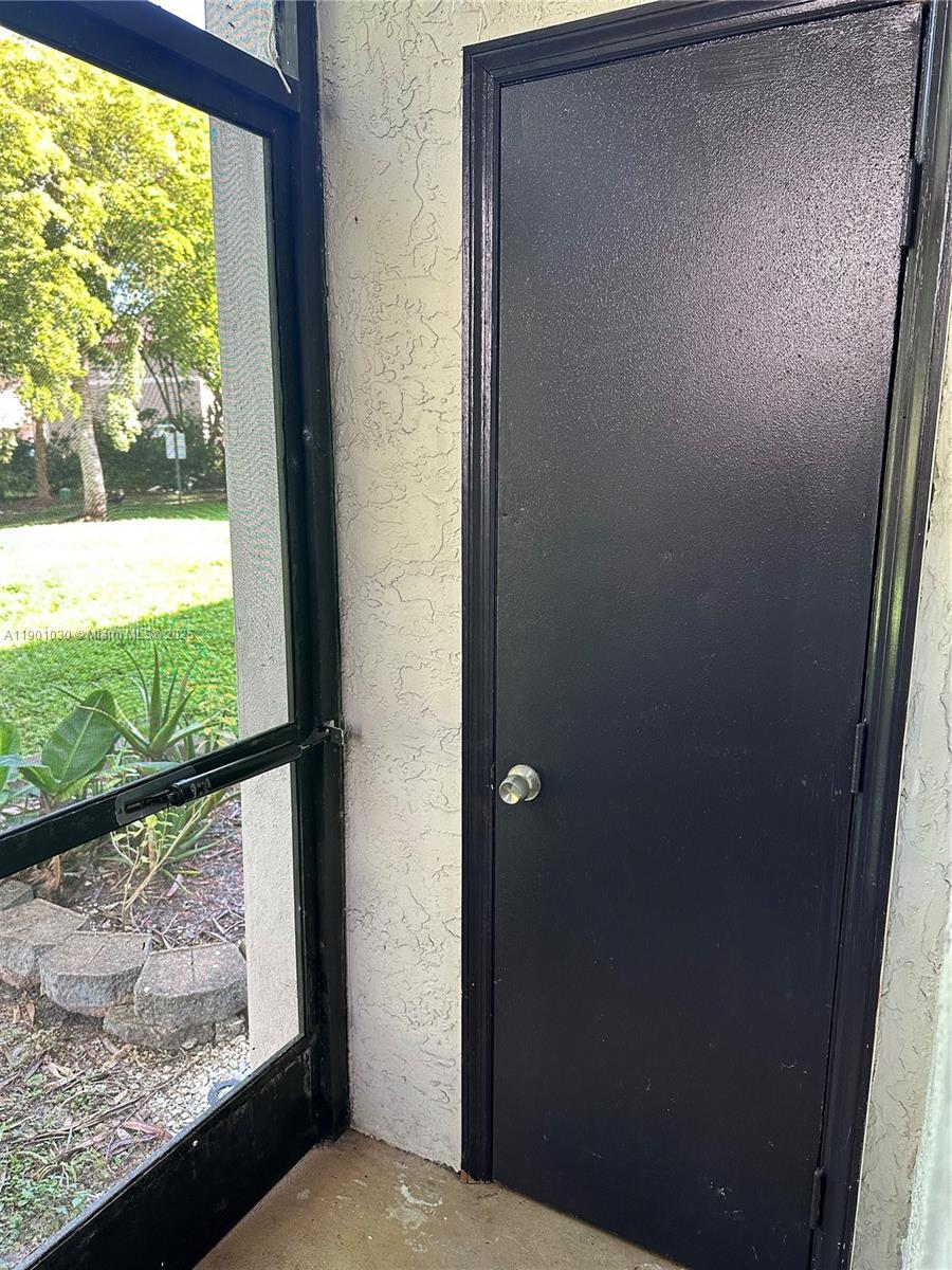 3037 Northwest 118th Drive, Unit 122D Coral Springs, FL 33065 - Photo 20 of 25 a view of a glass door and a window