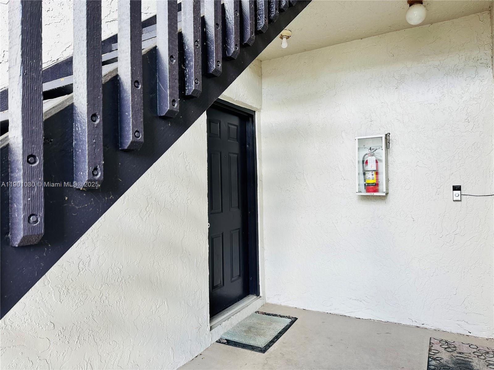 3037 Northwest 118th Drive, Unit 122D Coral Springs, FL 33065 - Photo 2 of 25 a view of staircase with lots of frames on wall and wooden floor