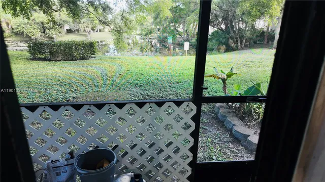 a view of a yard with wooden fence