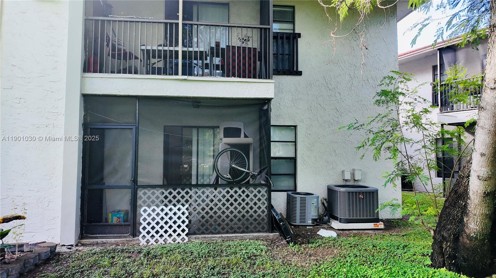 3037 Northwest 118th Drive, Unit 122D Coral Springs, FL 33065 - Photo 22 of 25 a front view of a house with a garden