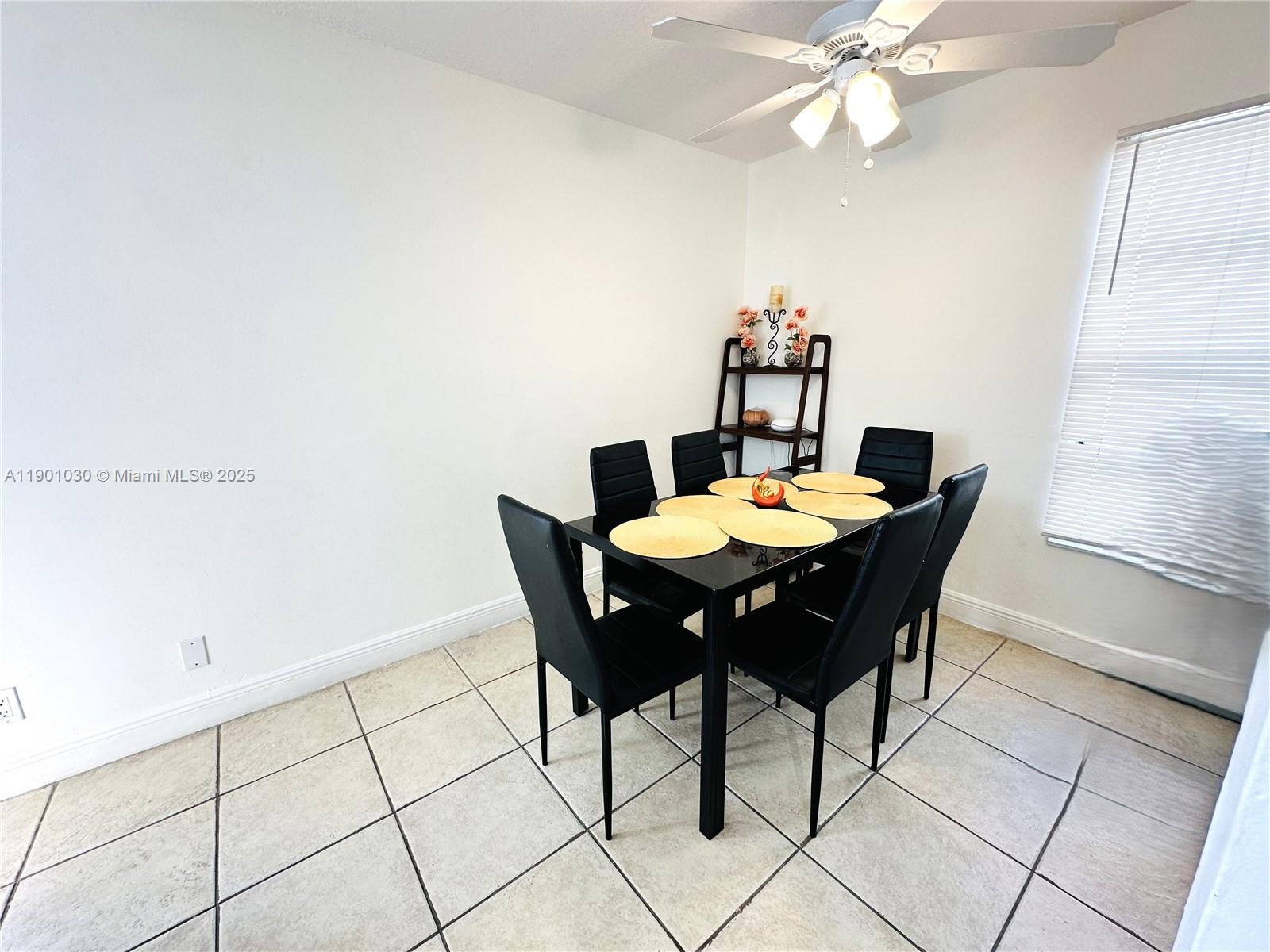 3037 Northwest 118th Drive, Unit 122D Coral Springs, FL 33065 - Photo 6 of 25 a dining room with furniture and chandelier