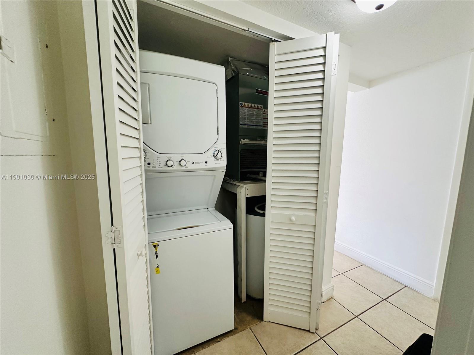 3037 Northwest 118th Drive, Unit 122D Coral Springs, FL 33065 - Photo 10 of 25 a utility room with dryer and washer