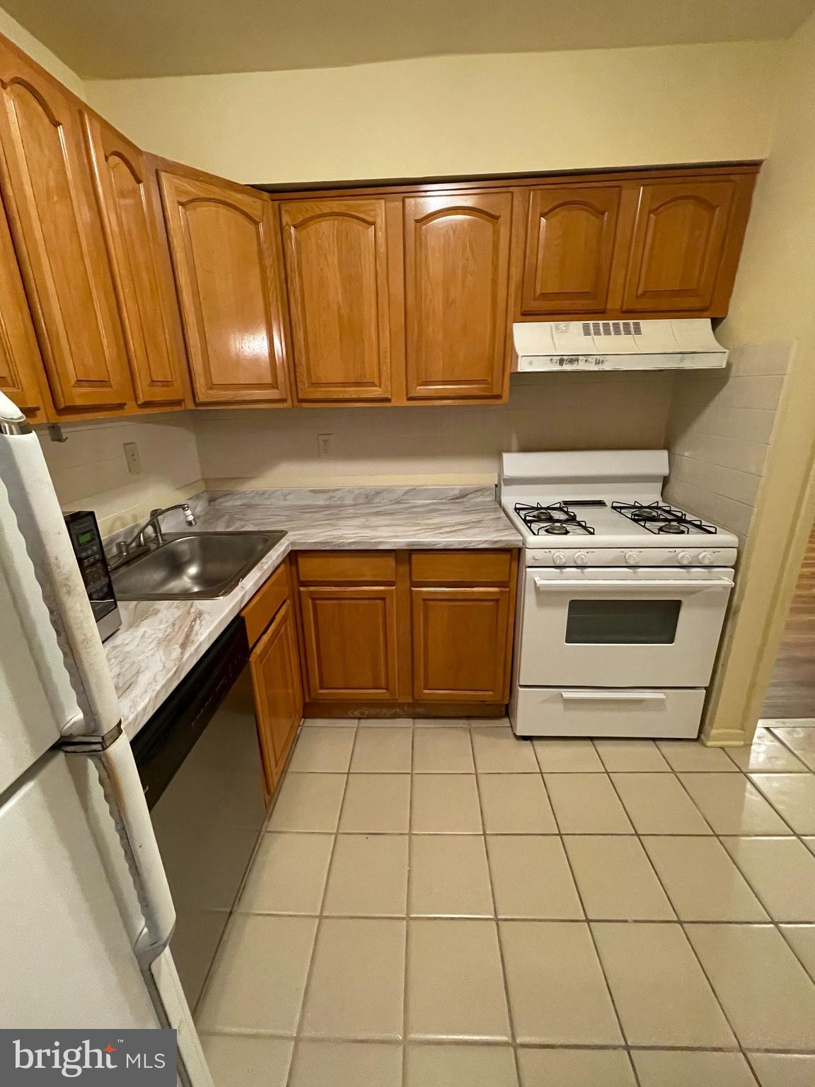 9653 White Acre Road, Unit C2 Columbia, MD 21045 - Photo 2 of 11 a kitchen with a stove a sink and a microwave