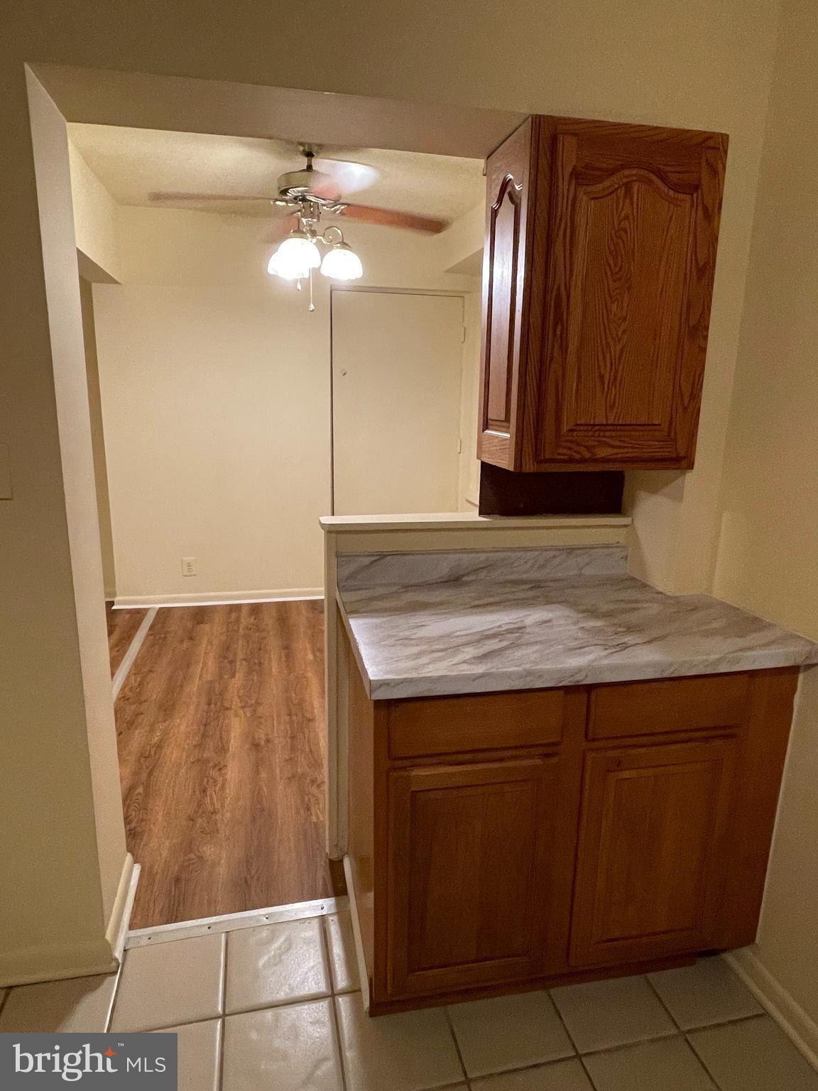 9653 White Acre Road, Unit C2 Columbia, MD 21045 - Photo 3 of 11 a bathroom with a granite countertop sink and a mirror