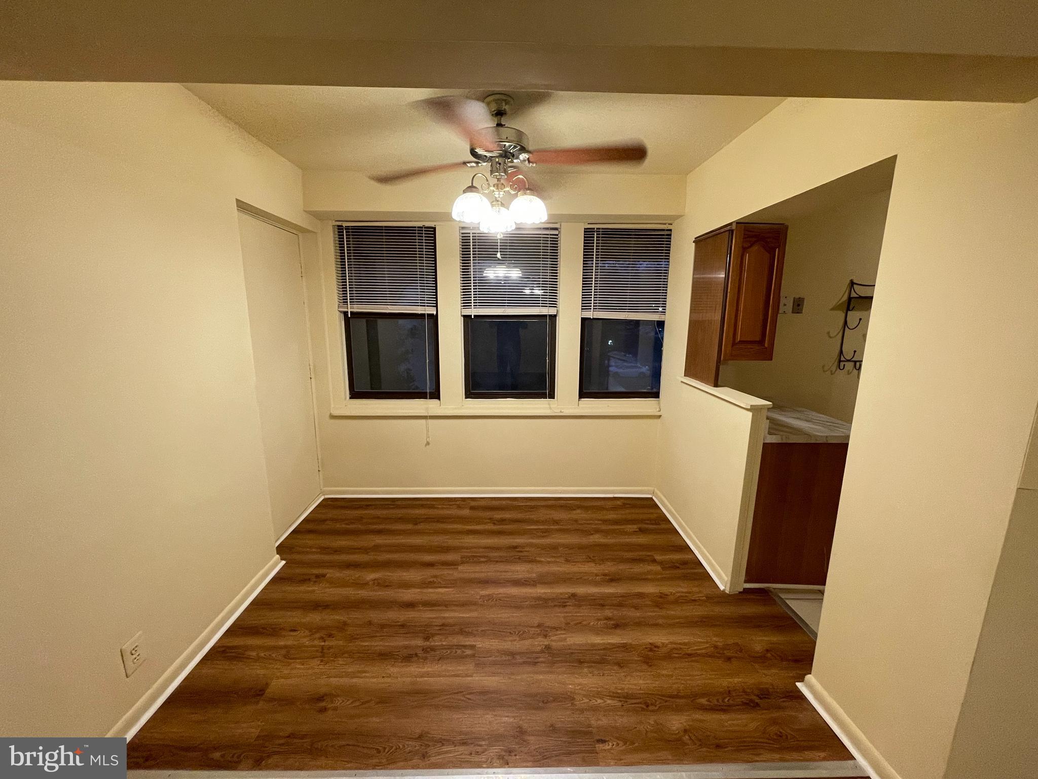 9653 White Acre Road, Unit C2 Columbia, MD 21045 - Photo 4 of 11 a view of an empty room with wooden floor and a window