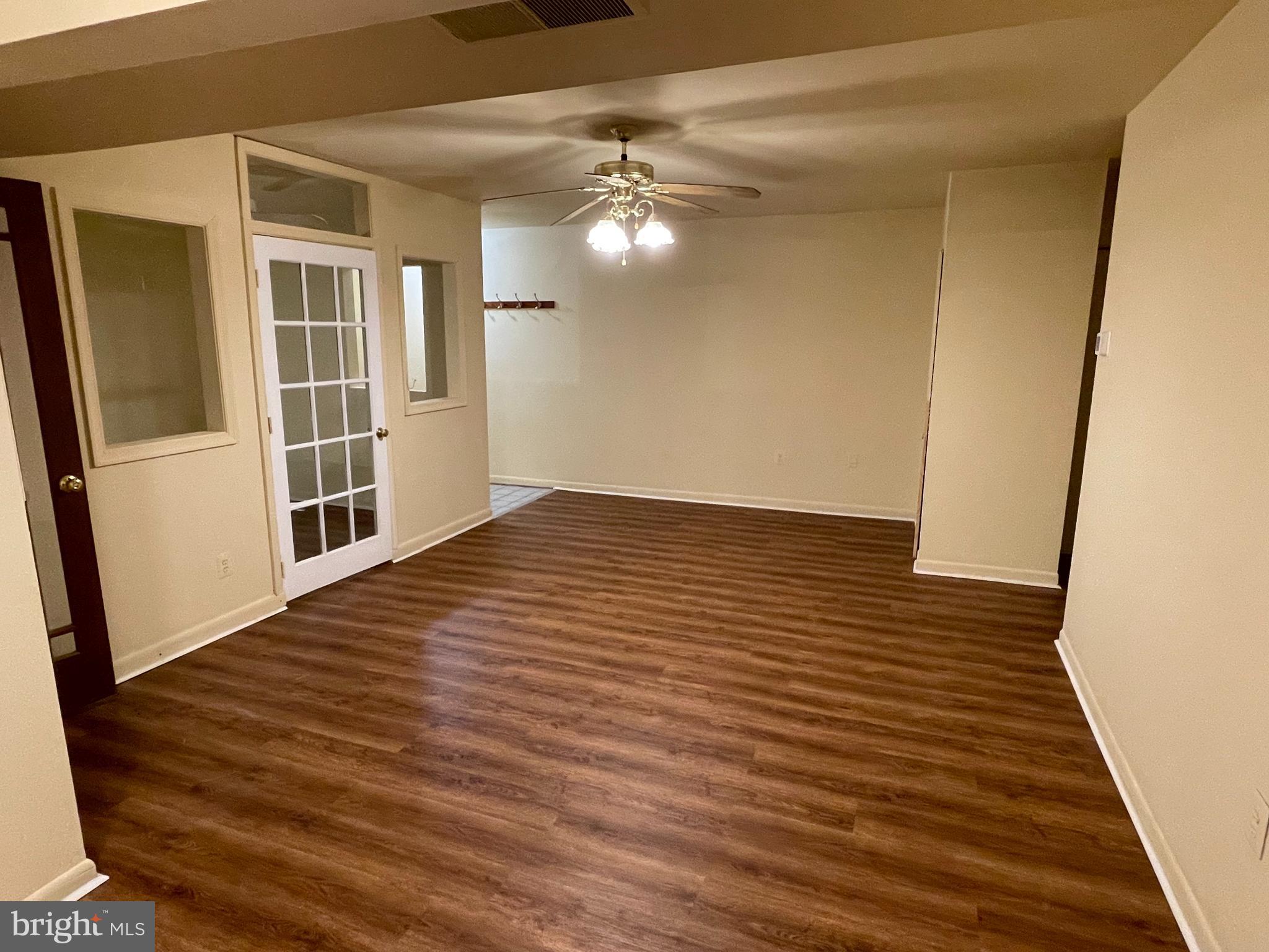 9653 White Acre Road, Unit C2 Columbia, MD 21045 - Photo 5 of 11 a view of a big room with wooden floor and cabinet