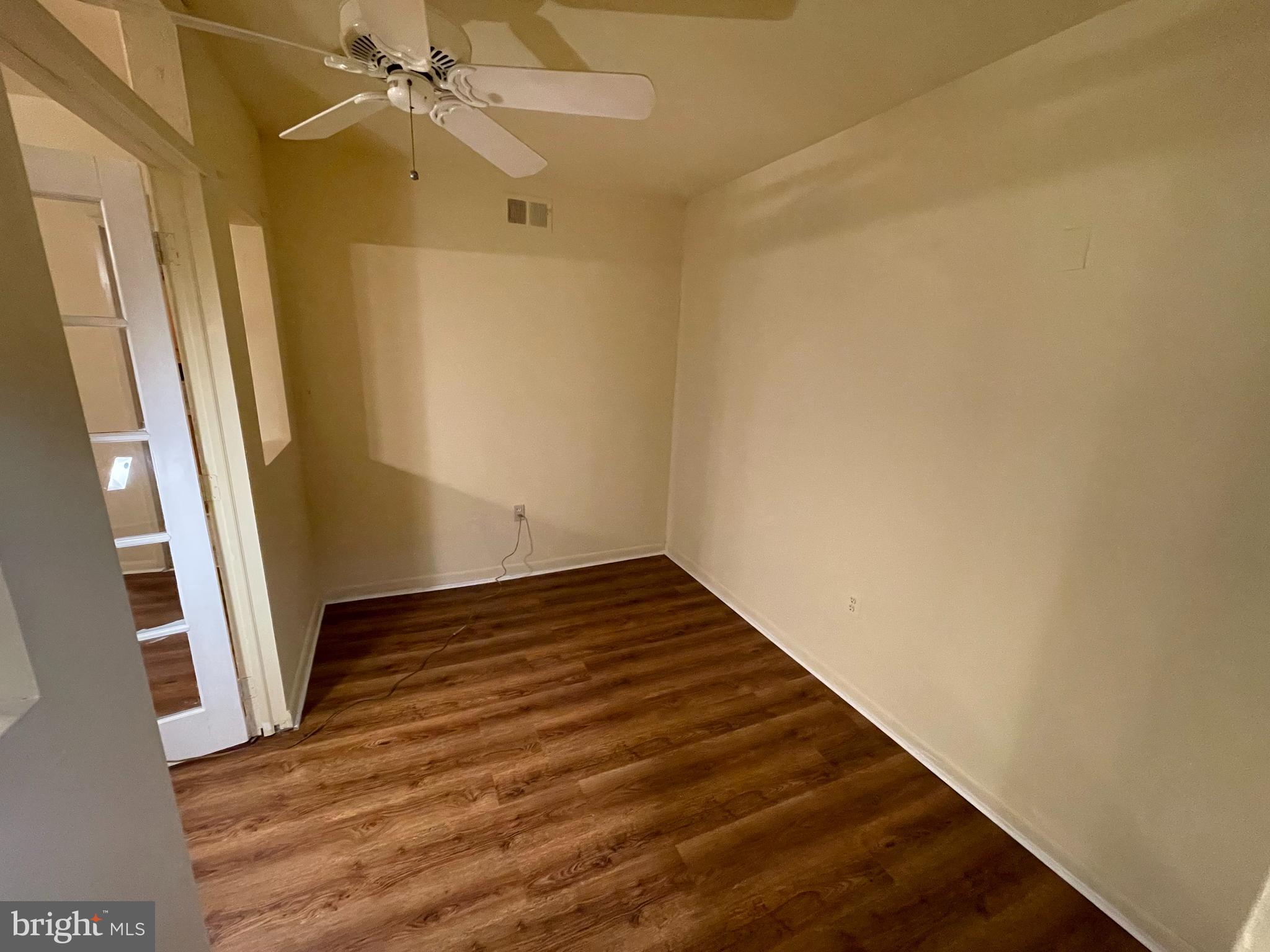 9653 White Acre Road, Unit C2 Columbia, MD 21045 - Photo 8 of 11 a view of an empty room with wooden floor and a window