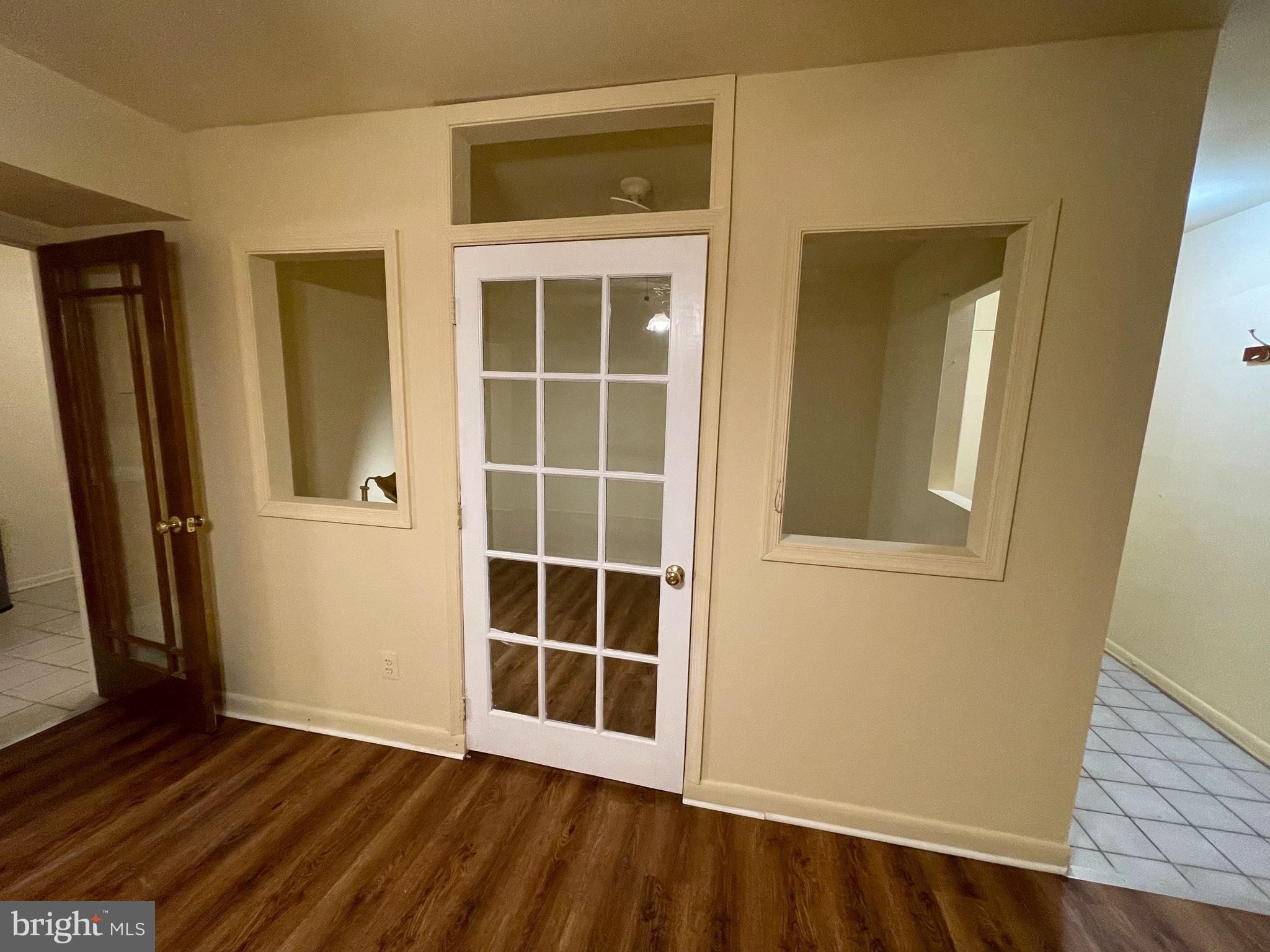 9653 White Acre Road, Unit C2 Columbia, MD 21045 - Photo 9 of 11 an empty room with wooden floor and a door