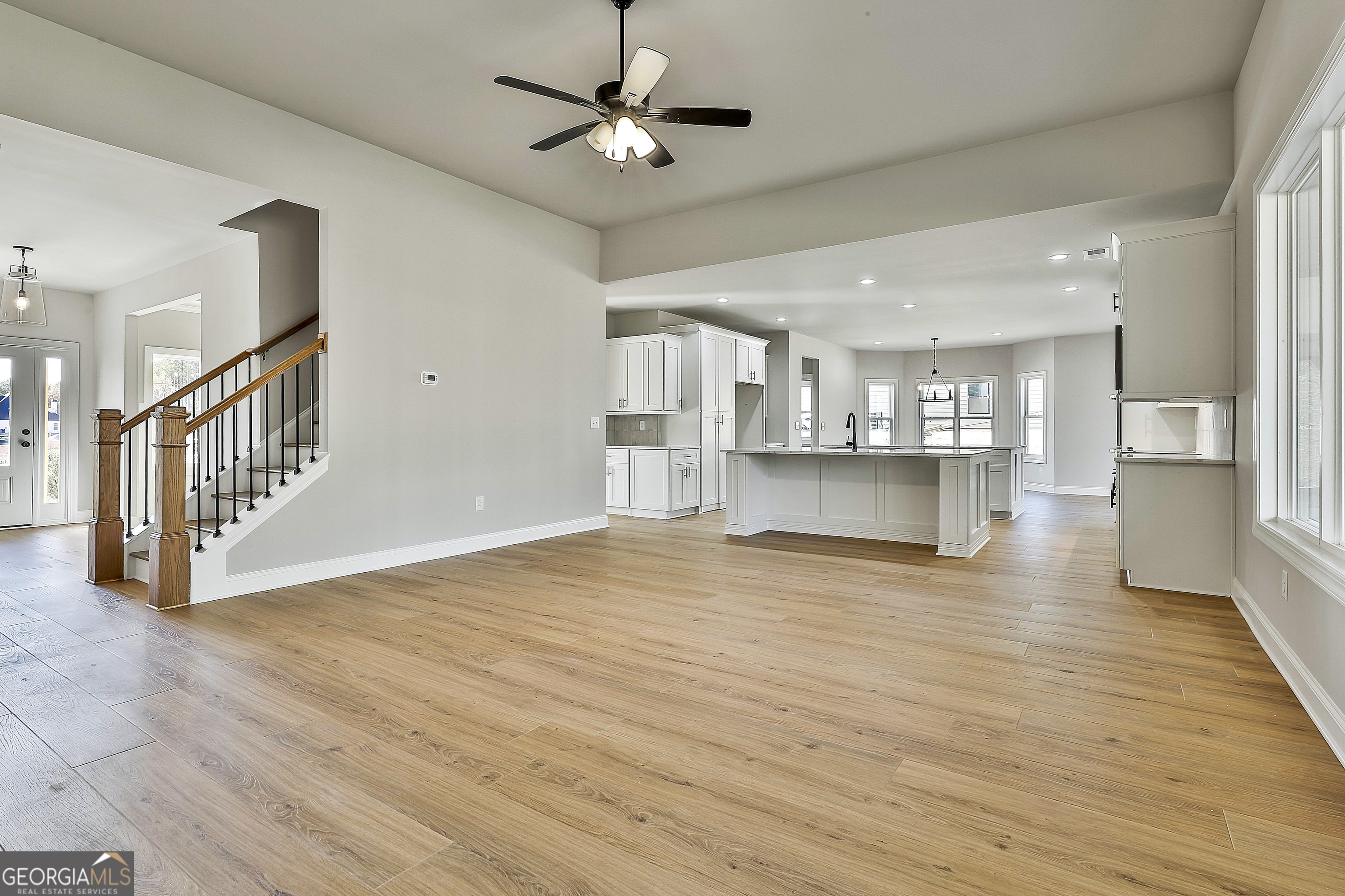 174 Tattersall Way, Unit 5100 Senoia, GA 30276 - Photo 13 of 40 a view of an empty room with a kitchen