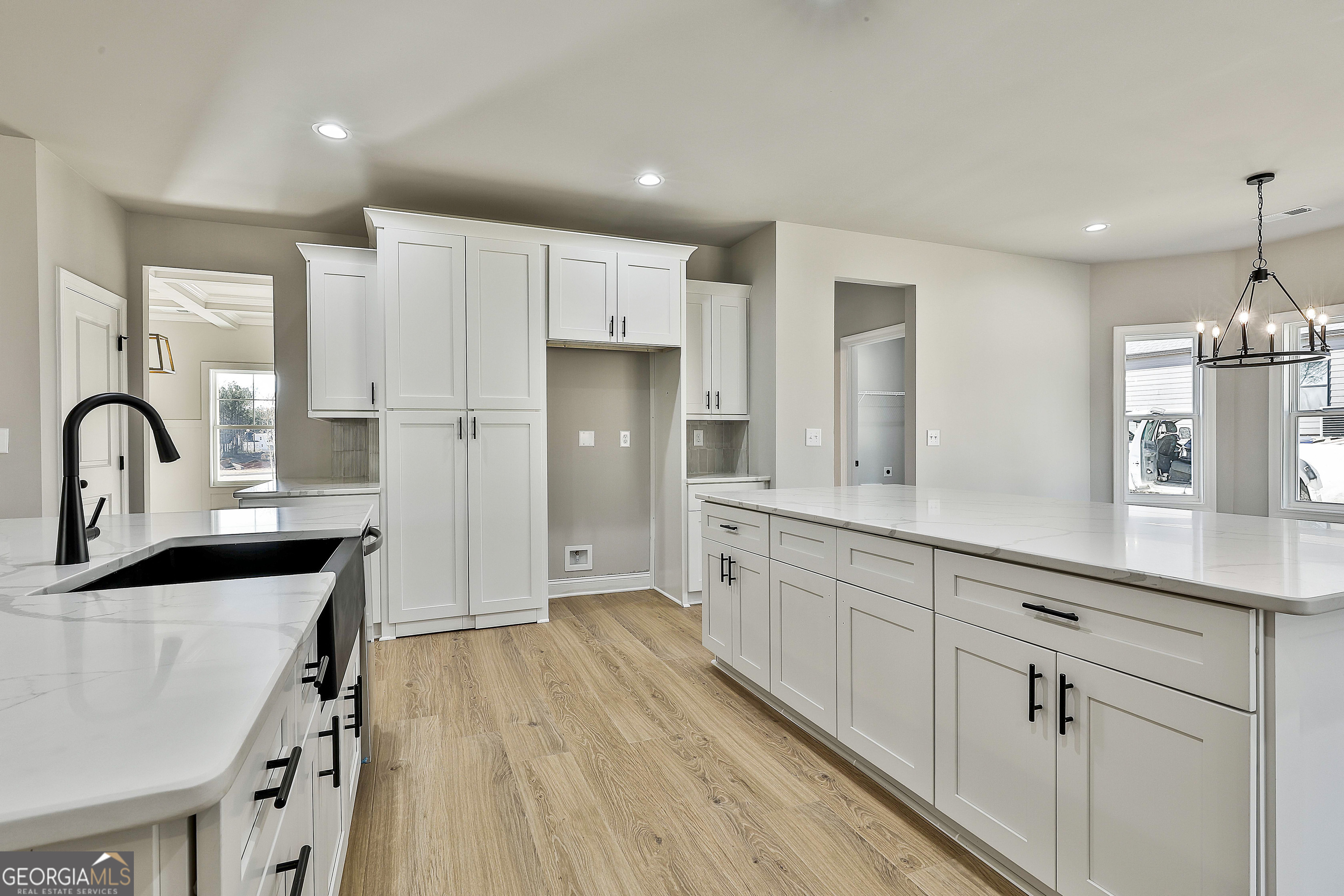 174 Tattersall Way, Unit 5100 Senoia, GA 30276 - Photo 18 of 40 a kitchen with granite countertop white cabinets and stainless steel appliances