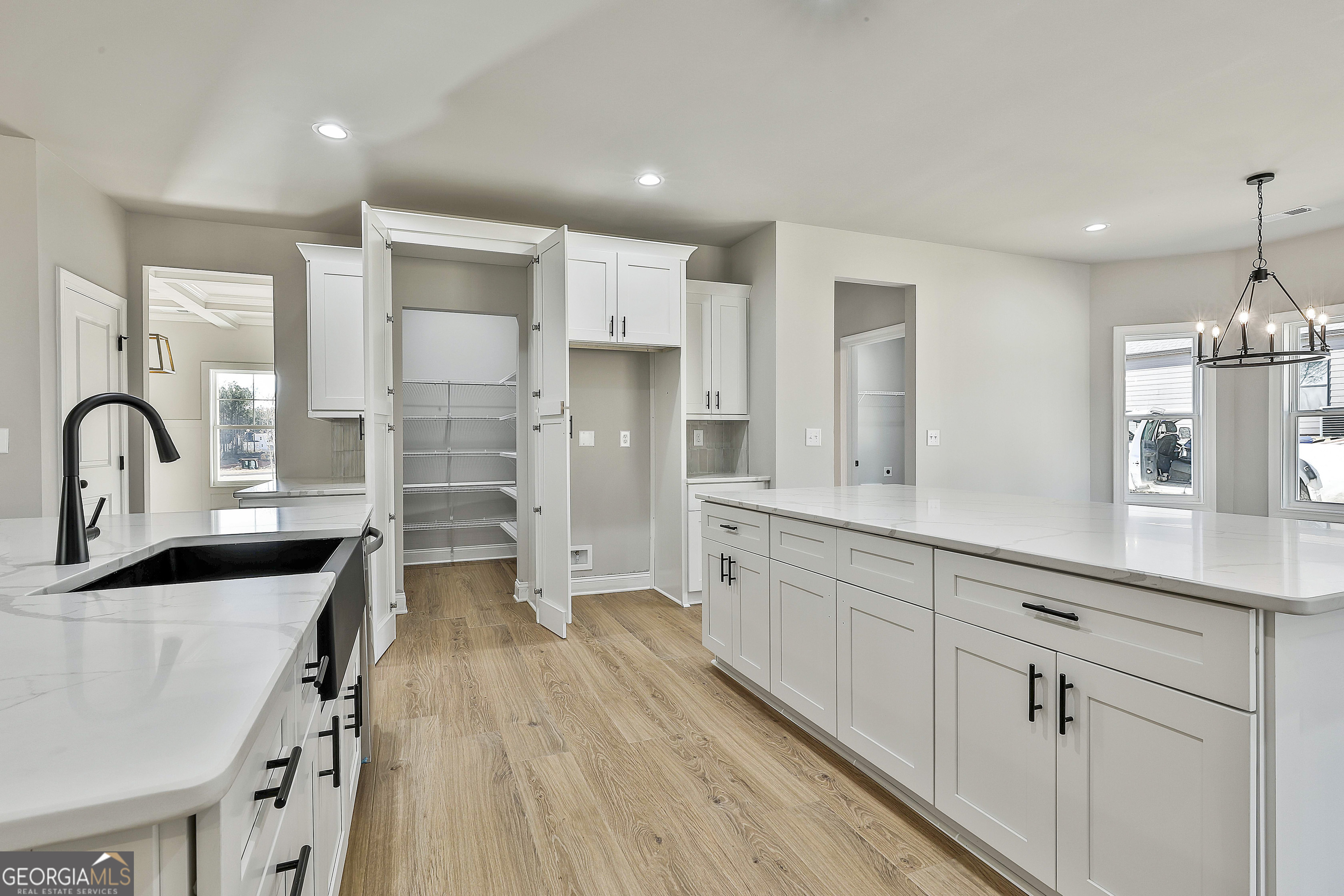 174 Tattersall Way, Unit 5100 Senoia, GA 30276 - Photo 19 of 40 a kitchen with cabinets a sink and appliances