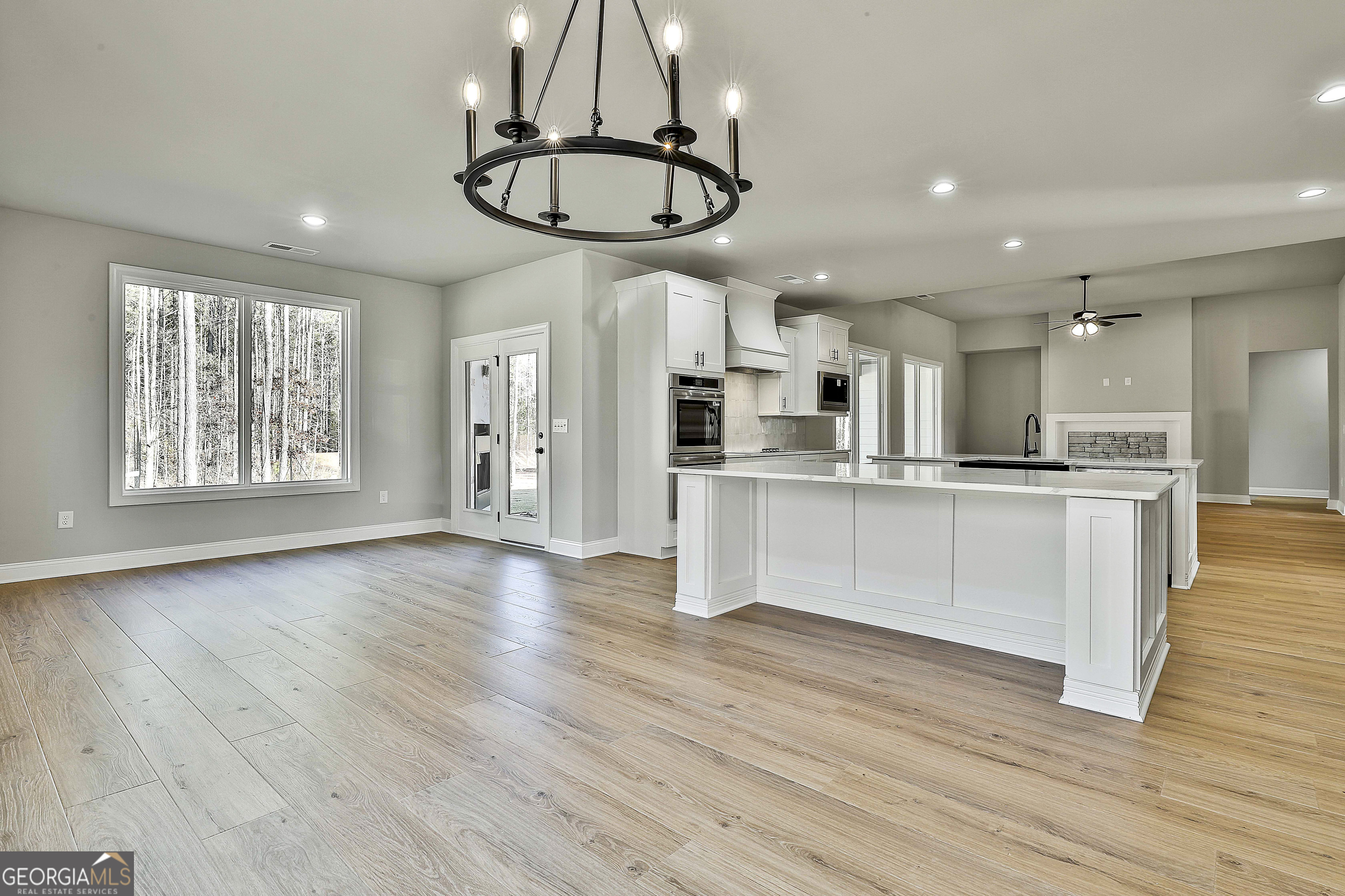 174 Tattersall Way, Unit 5100 Senoia, GA 30276 - Photo 22 of 40 a view of kitchen with stainless steel appliances granite countertop cabinets and wooden floor