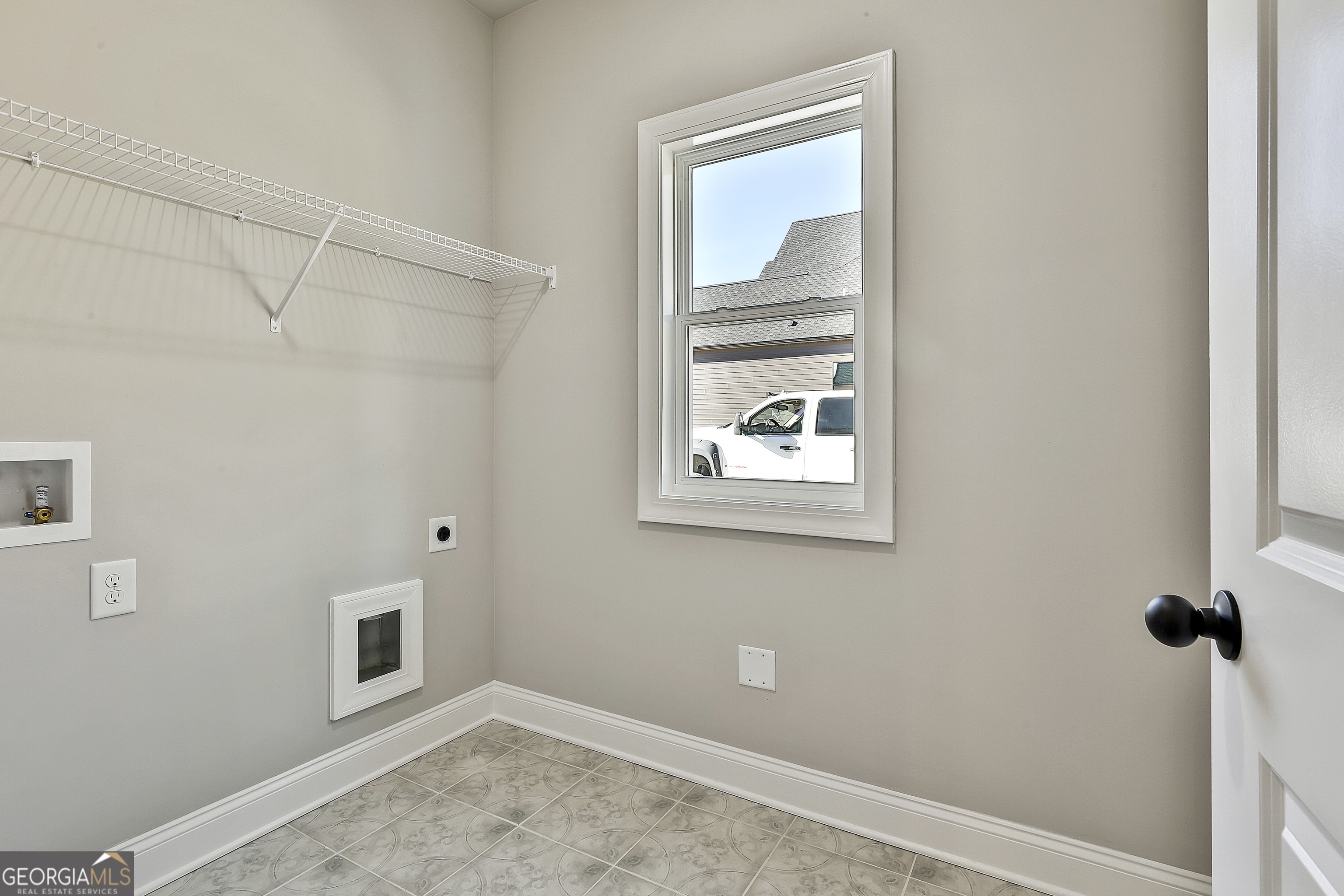 174 Tattersall Way, Unit 5100 Senoia, GA 30276 - Photo 23 of 40 a view of an empty room with a window