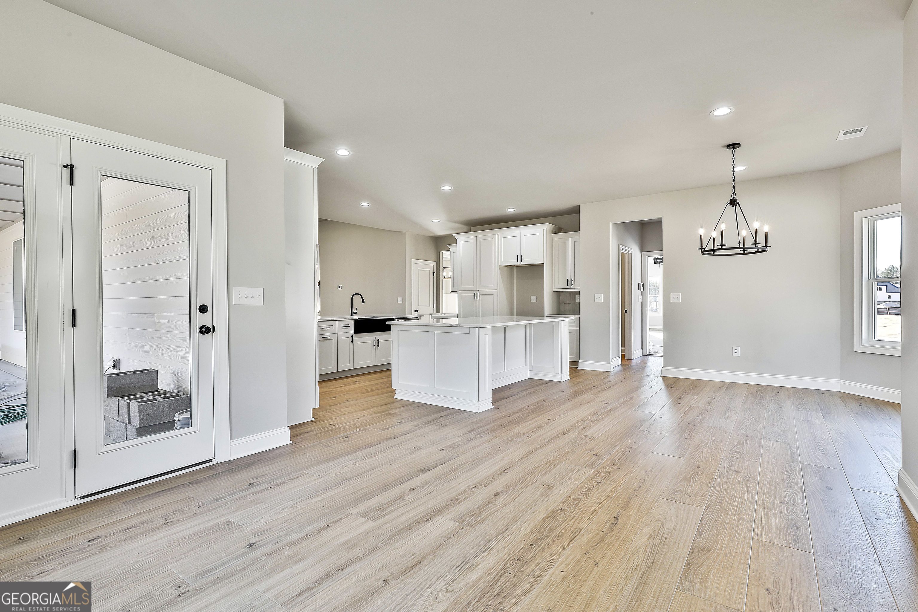 174 Tattersall Way, Unit 5100 Senoia, GA 30276 - Photo 25 of 40 a view of kitchen view wooden floor and window