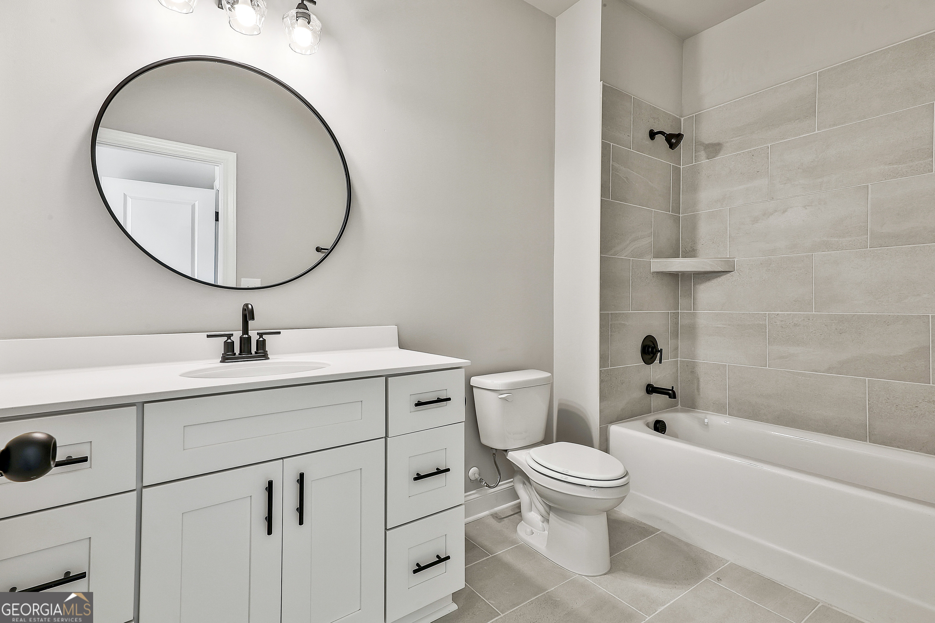 174 Tattersall Way, Unit 5100 Senoia, GA 30276 - Photo 33 of 40 a bathroom with a toilet a sink and a mirror