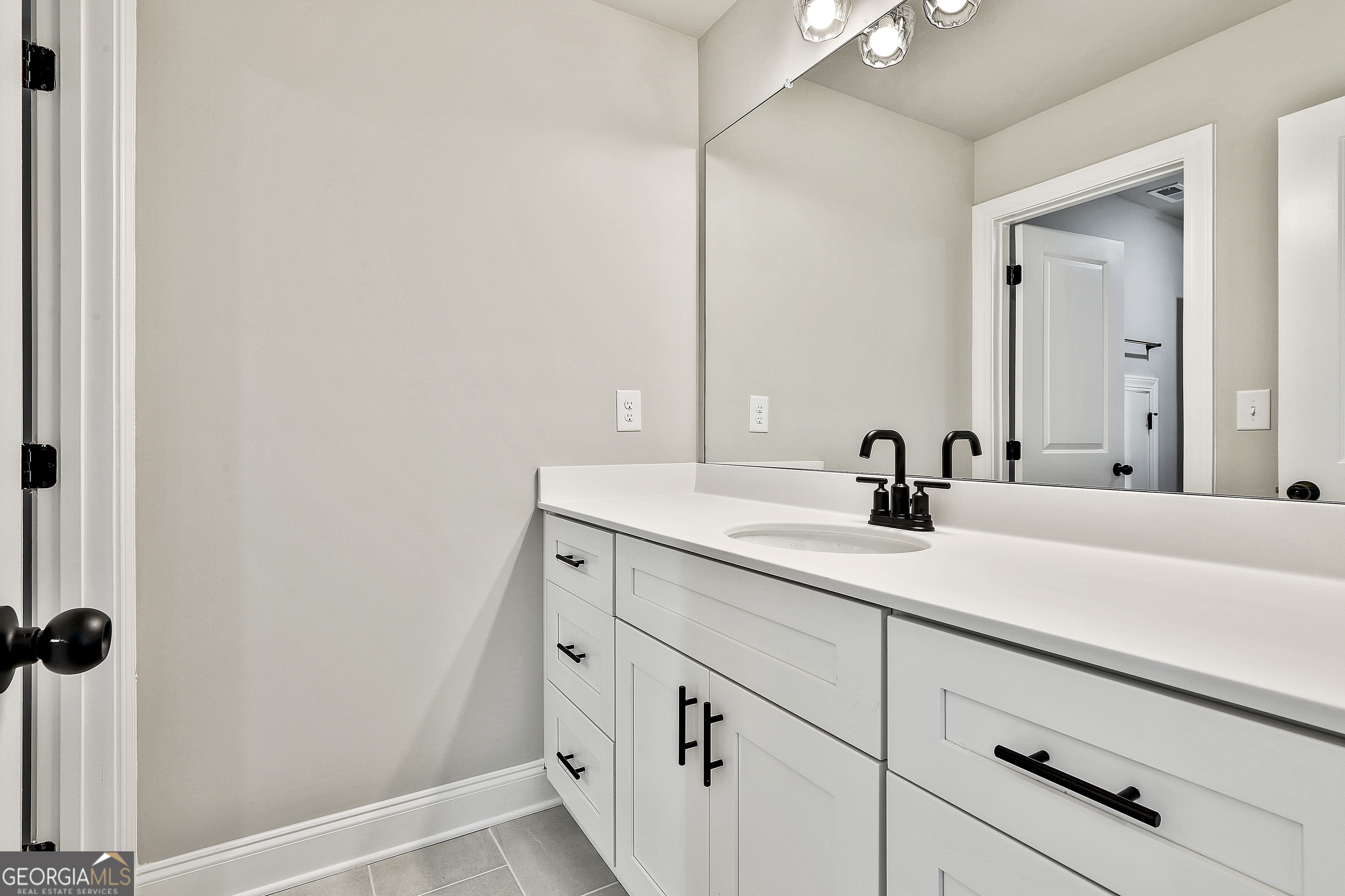 174 Tattersall Way, Unit 5100 Senoia, GA 30276 - Photo 36 of 40 a bathroom with a sink and mirror