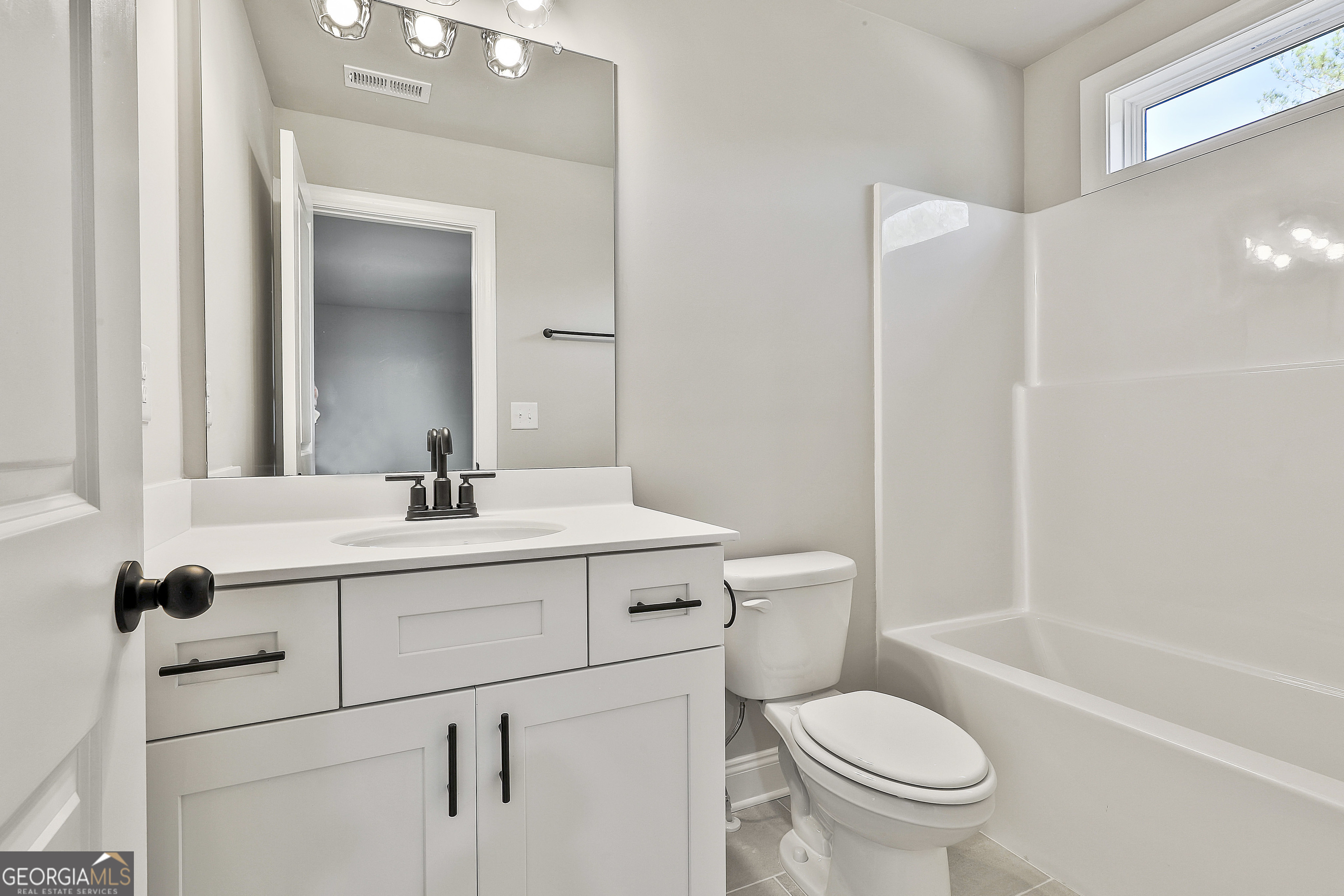 174 Tattersall Way, Unit 5100 Senoia, GA 30276 - Photo 39 of 40 a bathroom with a sink toilet vanity and tub