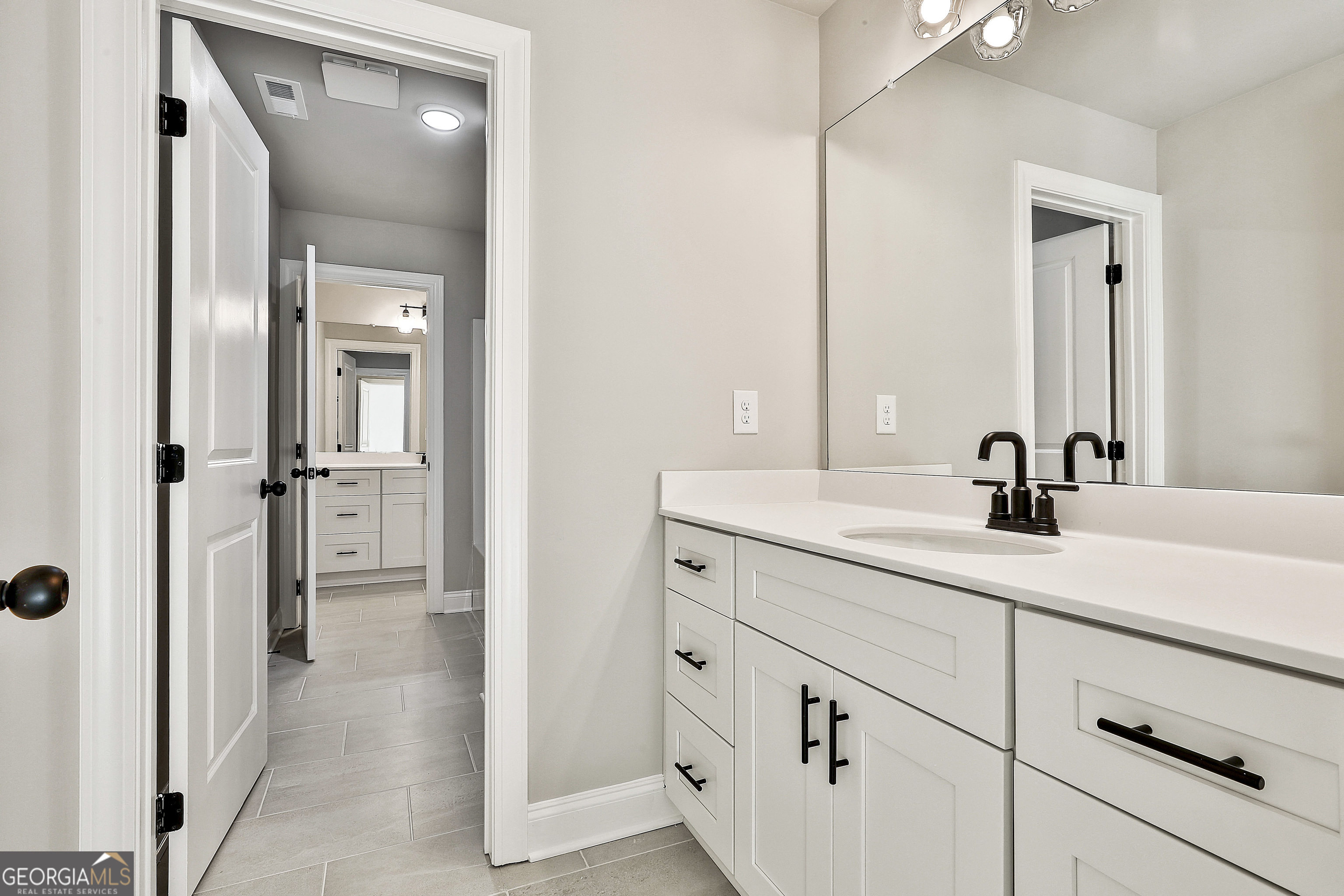 174 Tattersall Way, Unit 5100 Senoia, GA 30276 - Photo 40 of 40 a bathroom with a double vanity sink and mirror