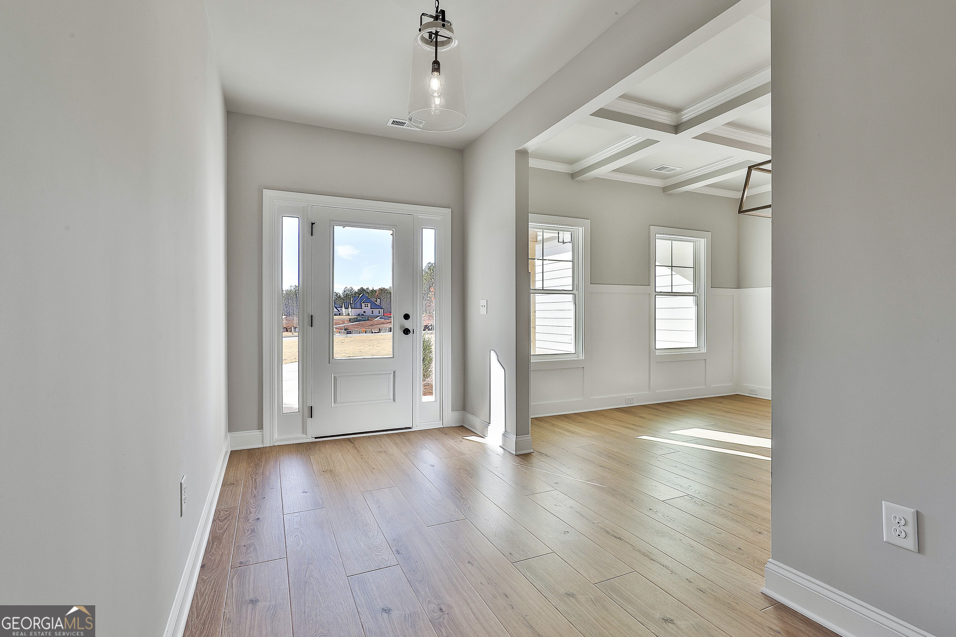 174 Tattersall Way, Unit 5100 Senoia, GA 30276 - Photo 4 of 40 wooden floor in an empty room with a window