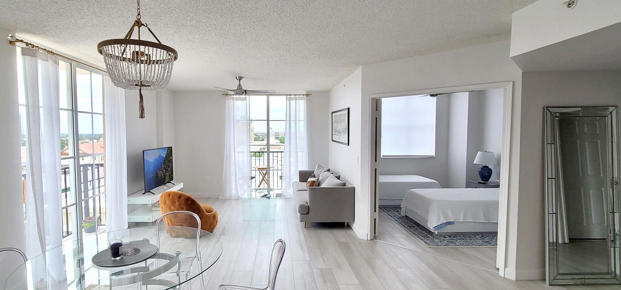 a bedroom with furniture and a large window