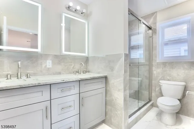 a white toilet sitting next to a bathroom sink