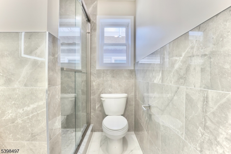 32 Garibaldi Avenue, Unit 3 Newark, NJ 07114 - Photo 16 of 20 a white toilet sitting next to a bathroom sink