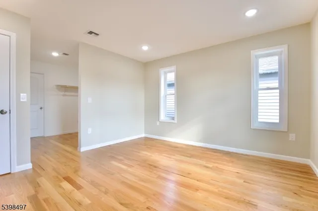 a view of a room with wooden floor