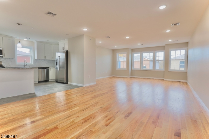 32 Garibaldi Avenue, Unit 3 Newark, NJ 07114 - Photo 5 of 20 a view of an empty room with a kitchen and a window