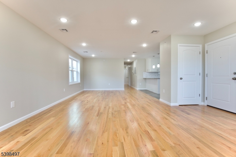 32 Garibaldi Avenue, Unit 3 Newark, NJ 07114 - Photo 6 of 20 a view of empty room with wooden floor and window