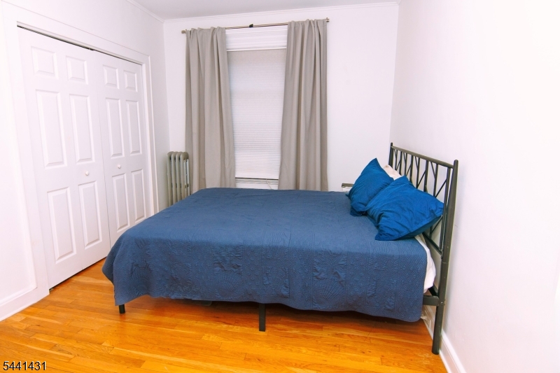 306 Springfield Avenue, Unit 1 Summit, NJ 07901 - Photo 9 of 17 a bedroom with a bed and a window