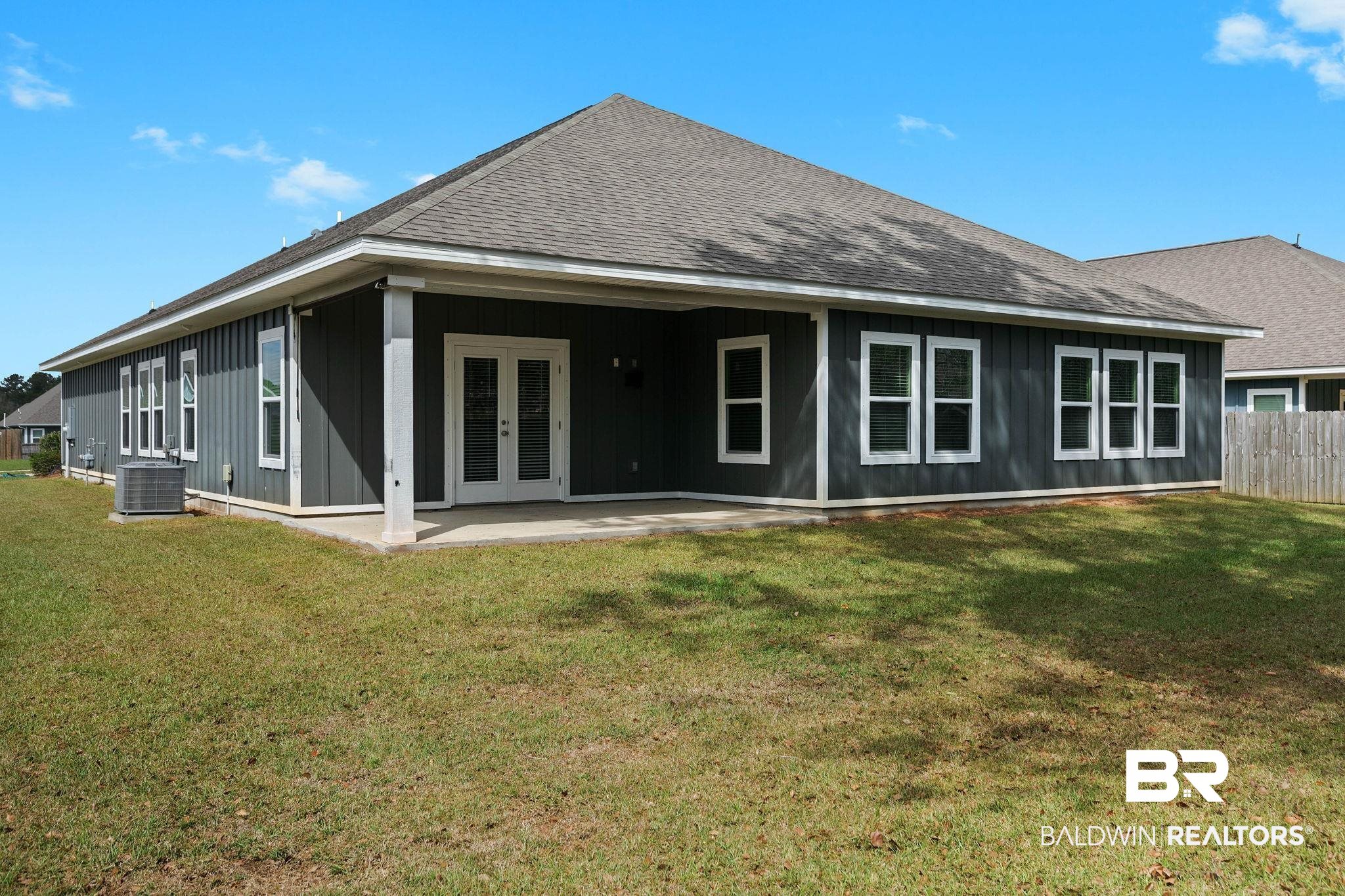 9448 Amethyst Drive Daphne, AL 36526 - Photo 55 of 61 Back of house featuring a shingled roof, board and batten siding, and a patio area