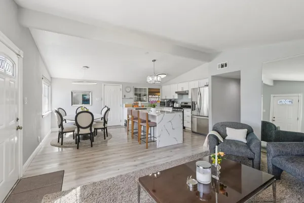 a kitchen with appliances a sink and cabinets