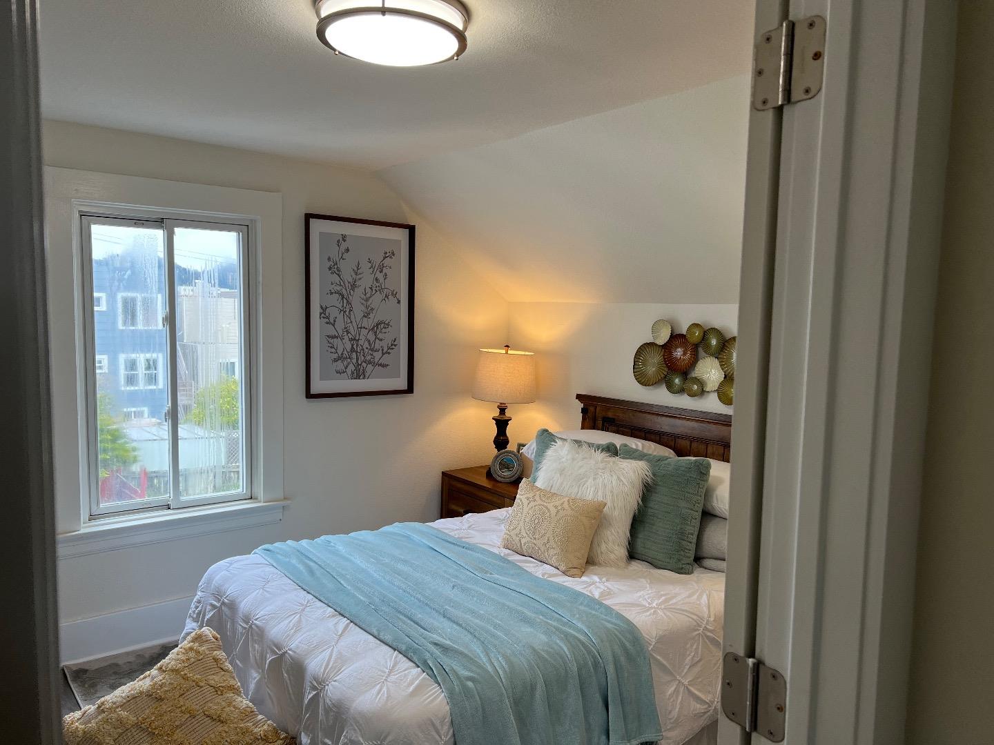 2270 22nd Avenue San Francisco, CA 94116 - Photo 11 of 12 a bedroom with a bed and a window