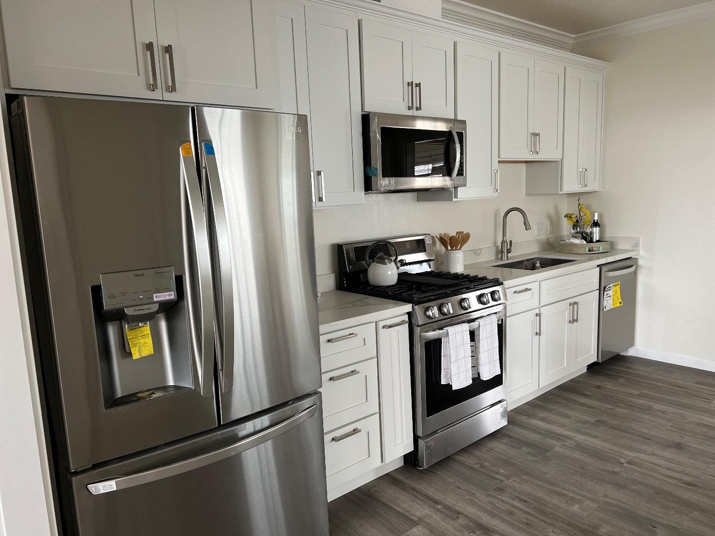 2270 22nd Avenue San Francisco, CA 94116 - Photo 8 of 12 a kitchen with stainless steel appliances a refrigerator stove and sink