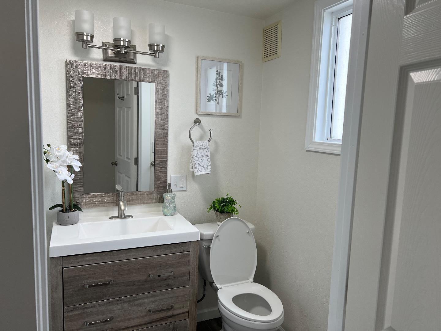 2270 22nd Avenue San Francisco, CA 94116 - Photo 9 of 12 a bathroom with a sink mirror and toilet