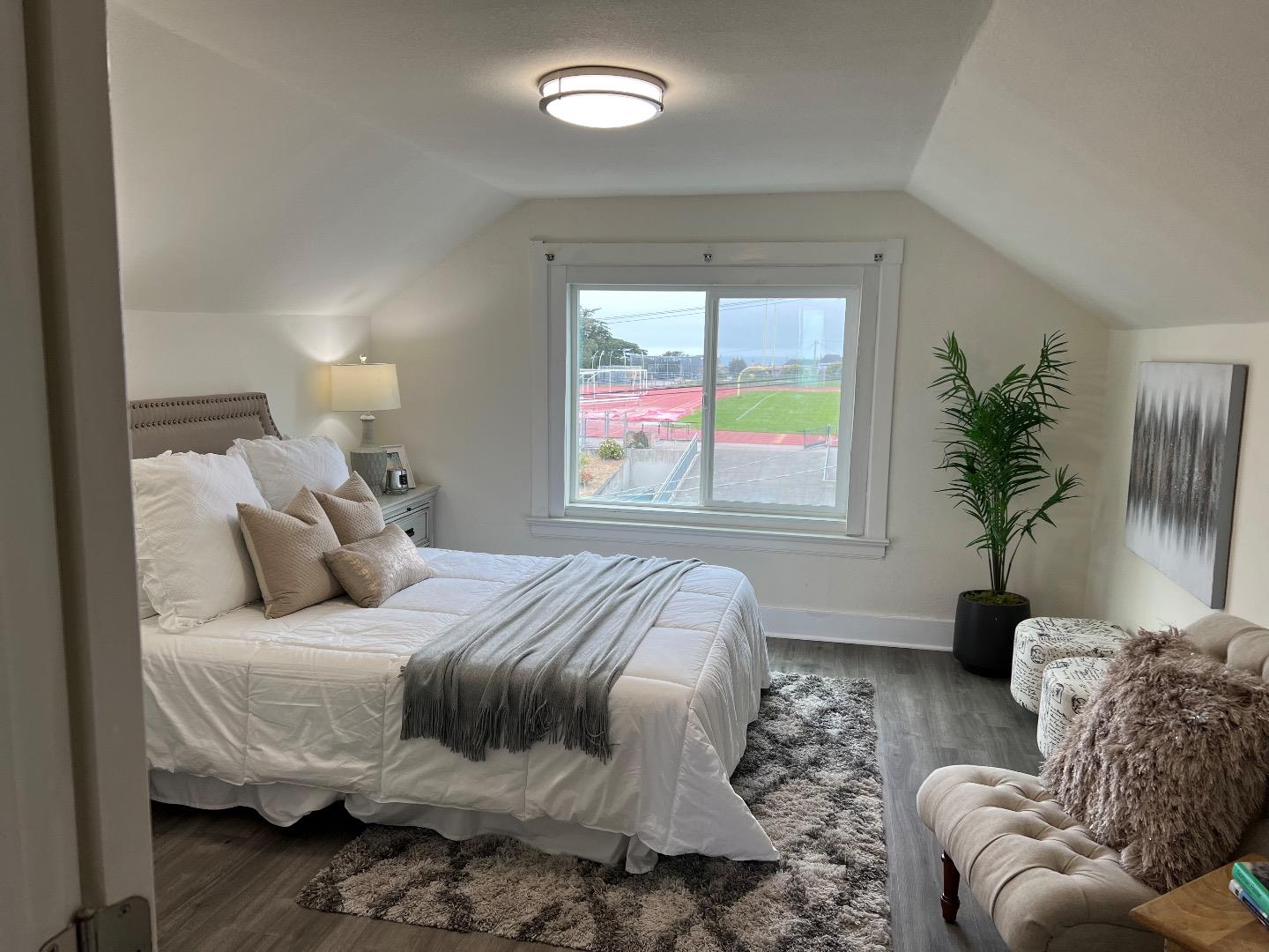 2270 22nd Avenue San Francisco, CA 94116 - Photo 10 of 12 a bedroom with a bed and glass window