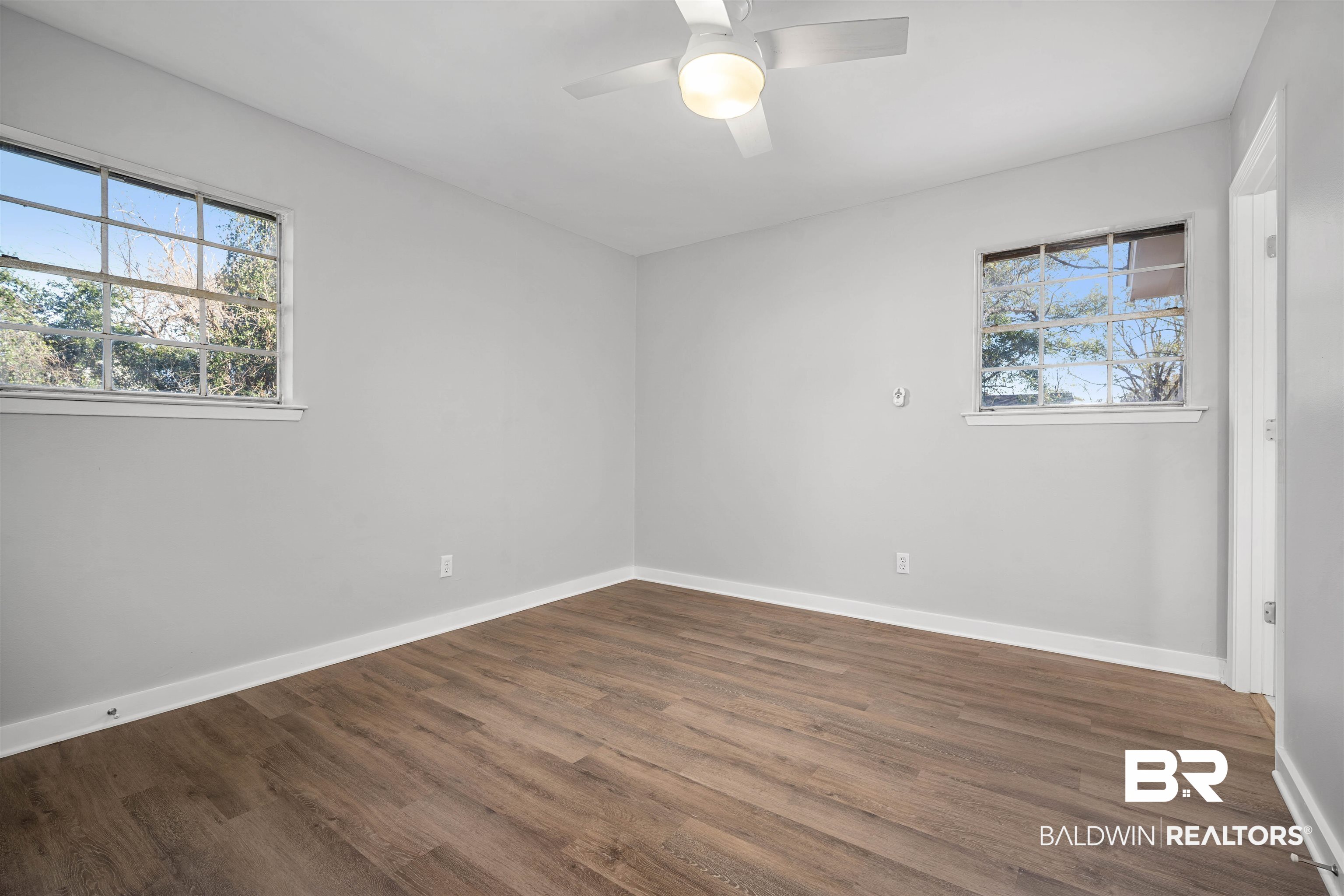 1368 Hubert Pierce Road Mobile, AL 36608 - Photo 13 of 25 Unfurnished room with dark wood-type flooring, plenty of natural light, and ceiling fan