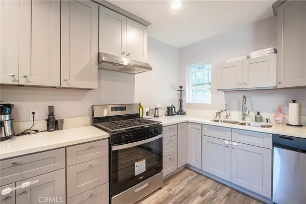 a kitchen with granite countertop white cabinets and white appliances