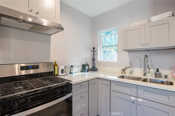 a kitchen with kitchen island a sink stove and cabinets