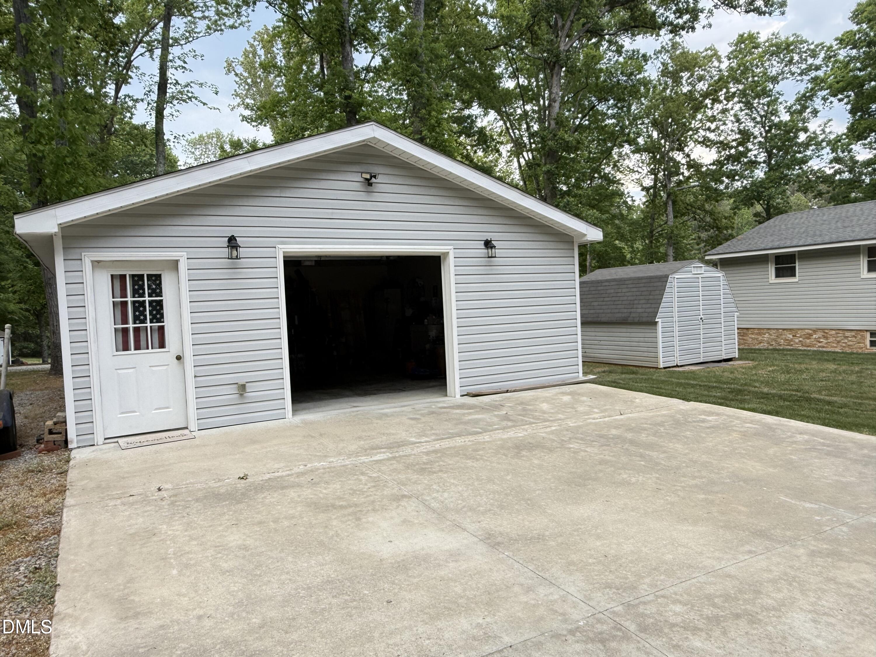 118 Paradise Point Macon, NC 27551 - Photo 19 of 28 a view of house with yard and trees in the background